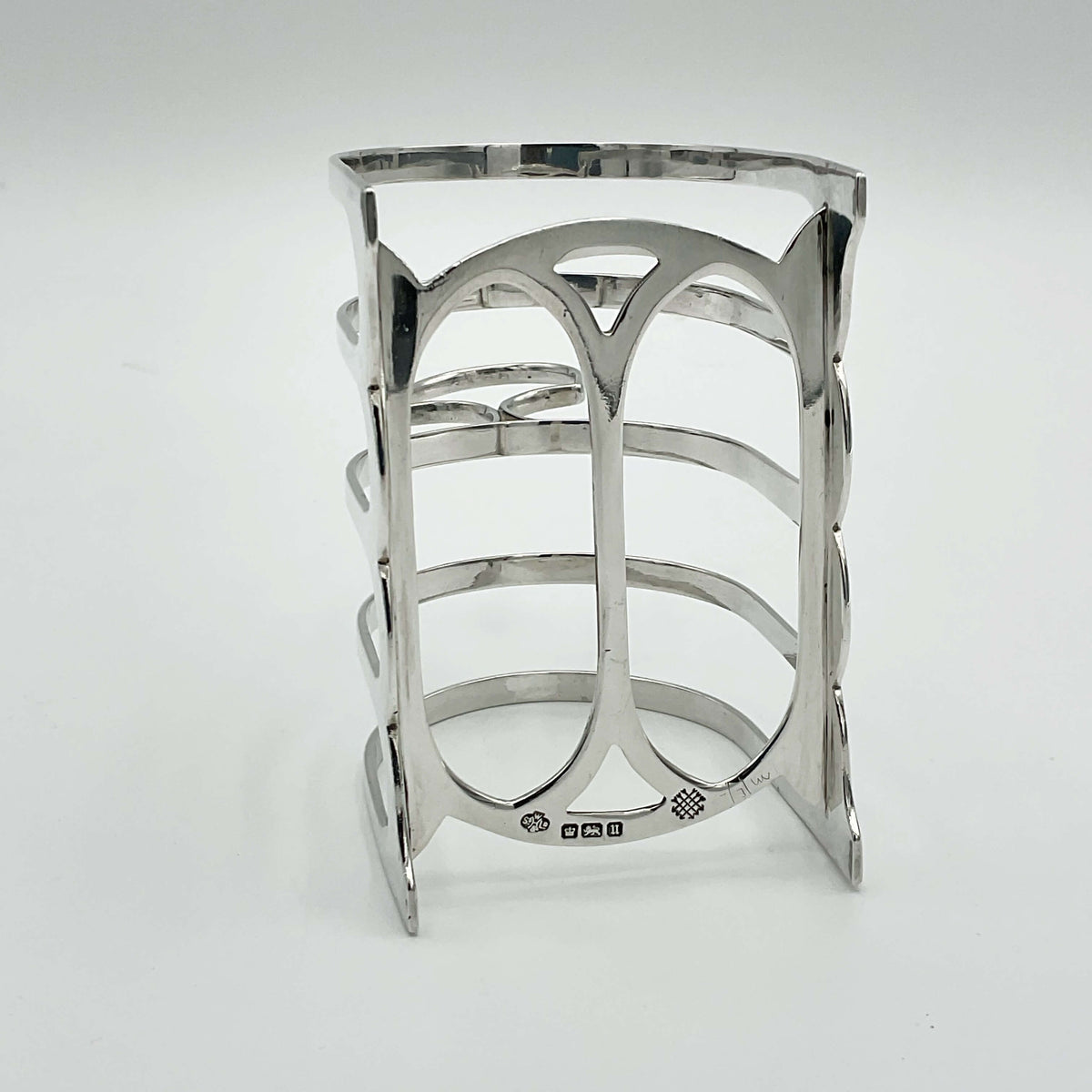 Antique 1912 Sterling Silver Toast Rack by Beeches Vintage, featuring intricate design and polished finish on a wooden surface.