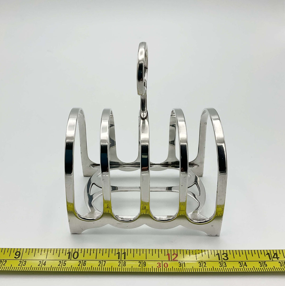 Antique 1912 sterling silver toast rack with ornate design, crafted by Beeches Vintage, showcasing detailed craftsmanship.