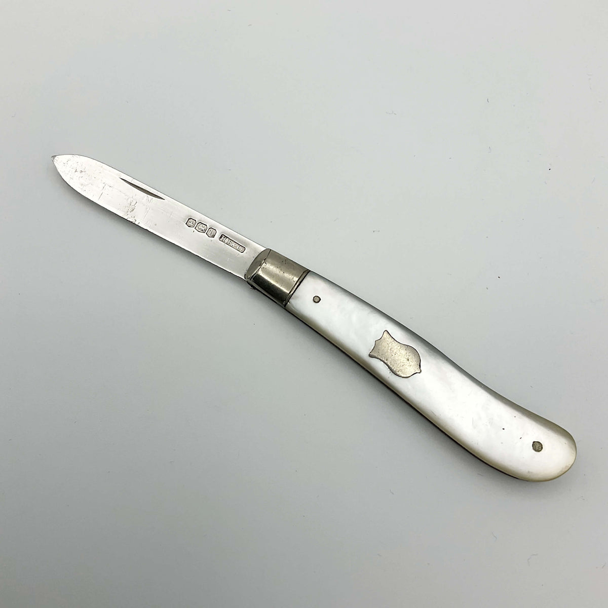 Vintage 1925 Beeches Vintage sterling silver fruit knife with intricate handle design on a neutral background.