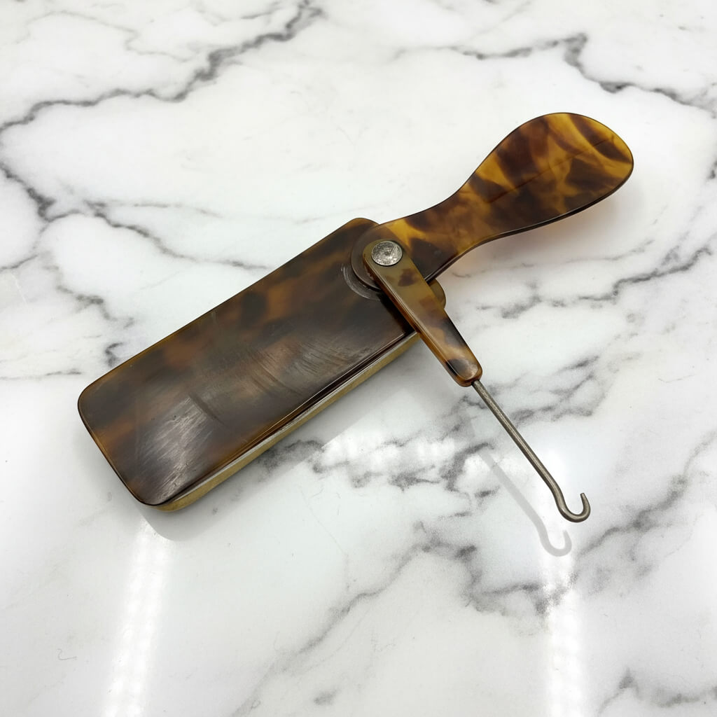 vintage Shoe hook horn and buffer on marble background