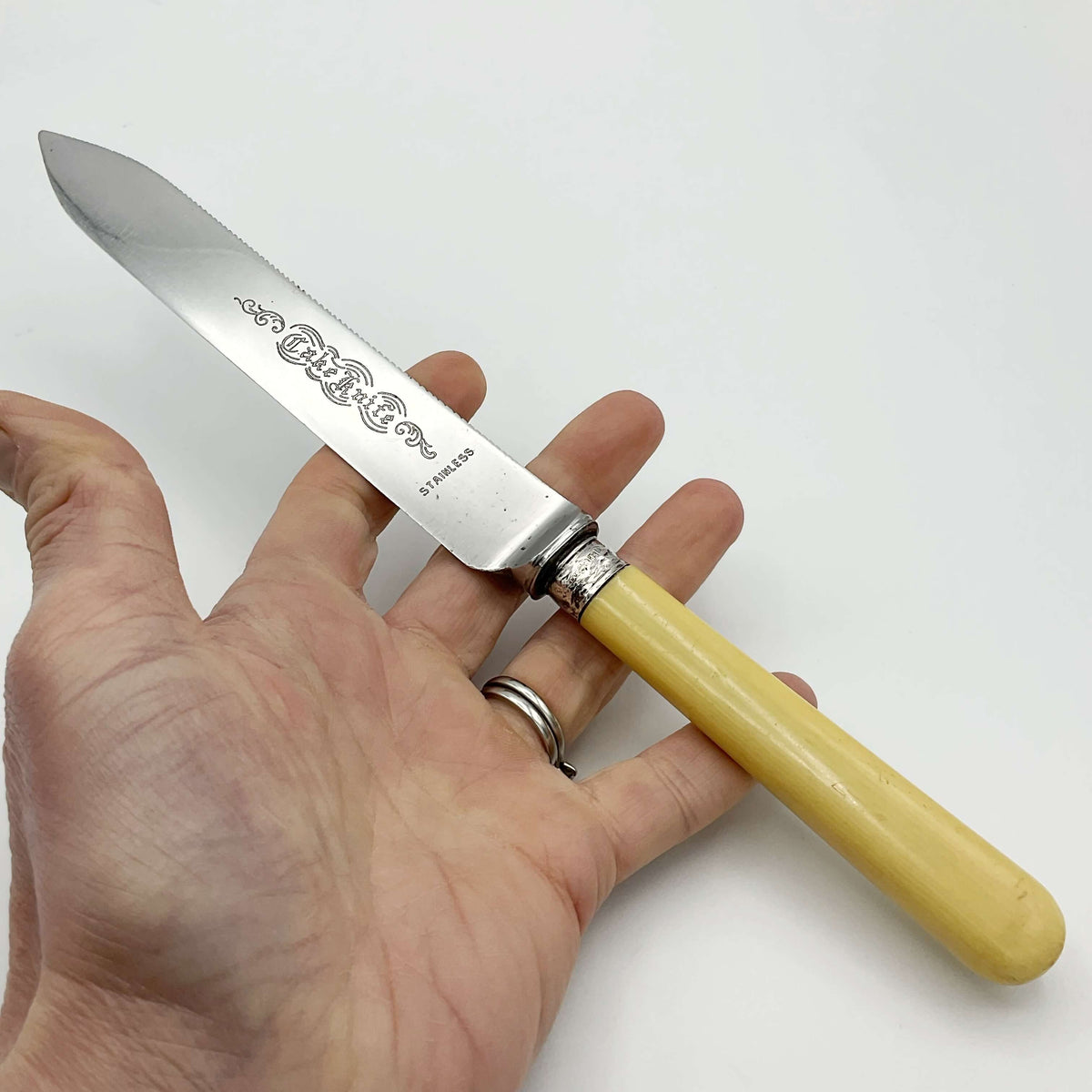 10 inch wedding cake knife sitting across a hand