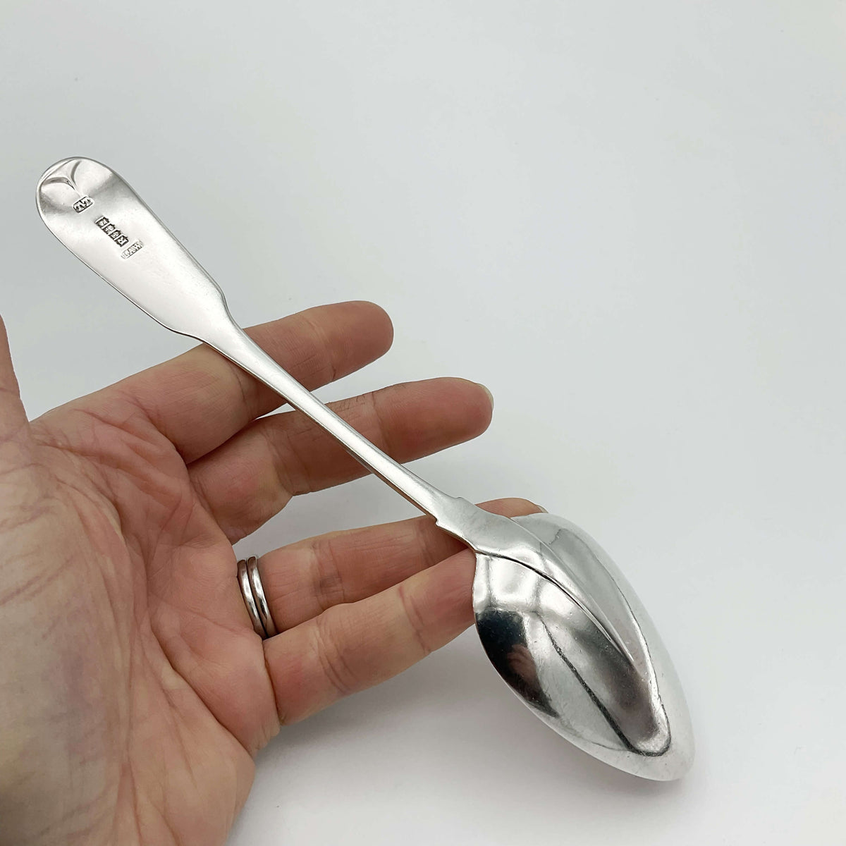 Antique 1813 Sterling Silver Dessert Spoon by Beeches Vintage, detailed ornate handle with polished silver finish.