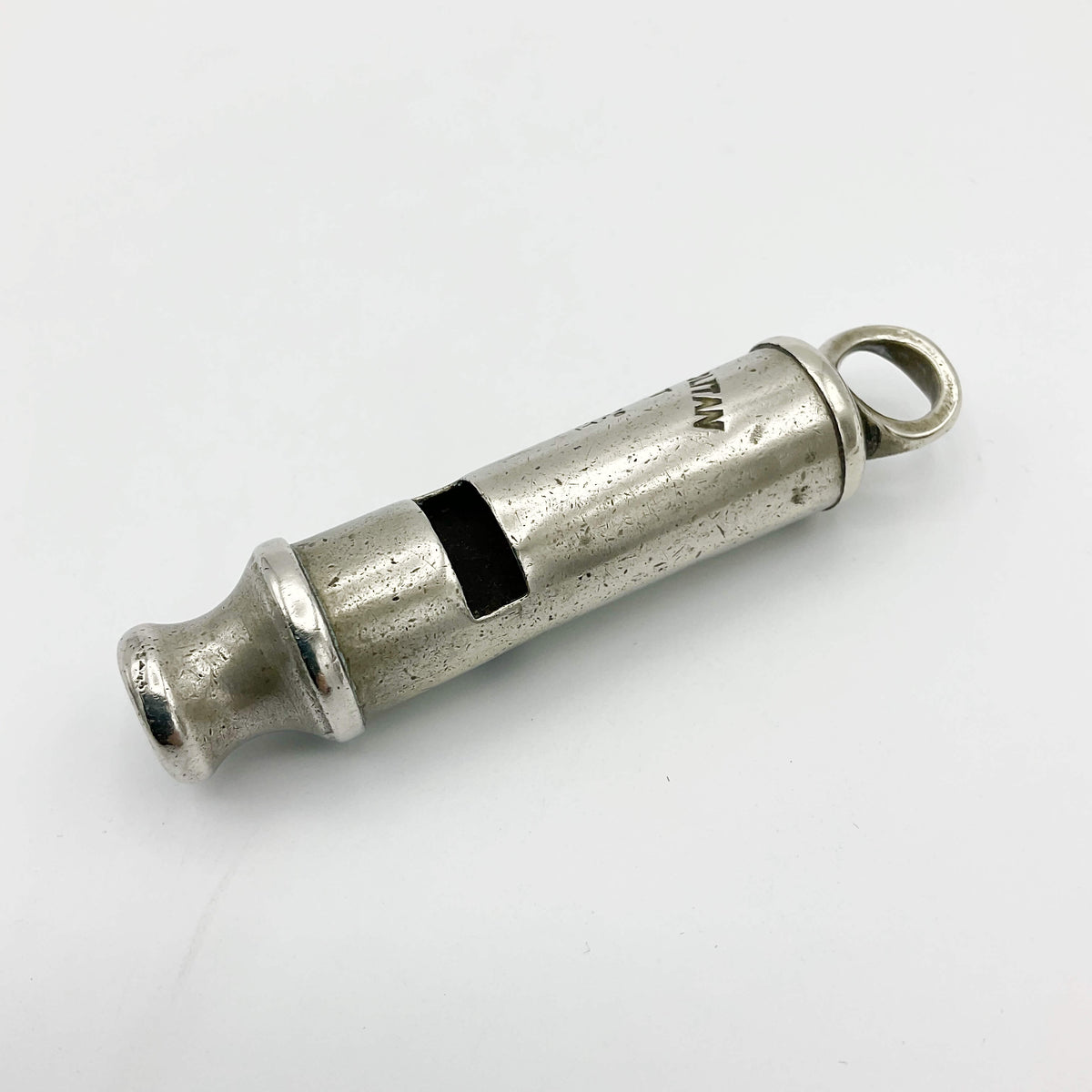 Antique police whistle from Beeches Vintage, vintage metal accessory with a classic design, displayed on a plain background.