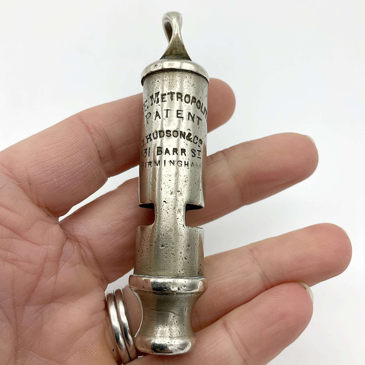 Antique police whistle from Beeches Vintage, vintage metal accessory with a classic design, shown in close-up detail.