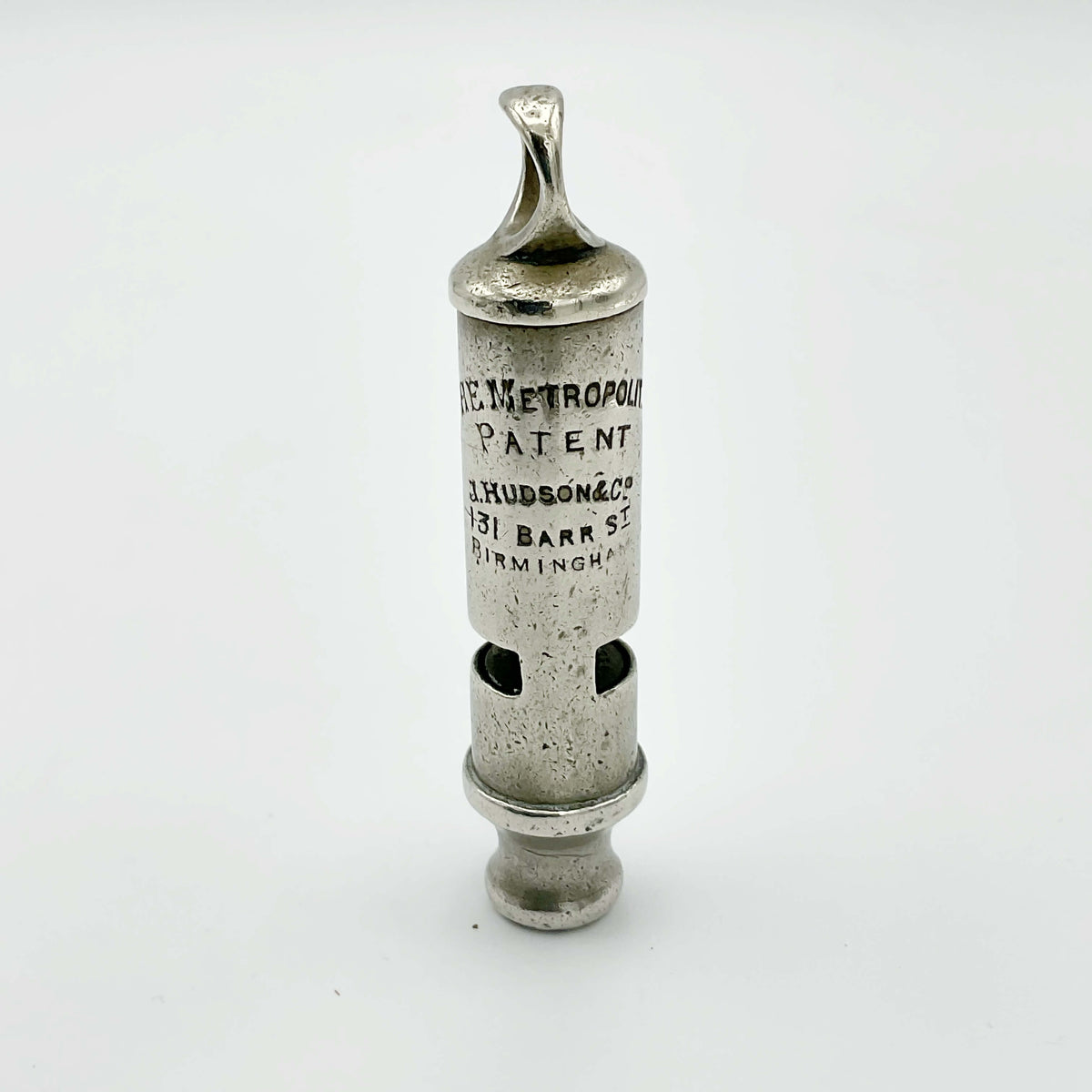 Antique police whistle from Beeches Vintage, vintage metal accessory with a classic design, resting on a neutral background.
