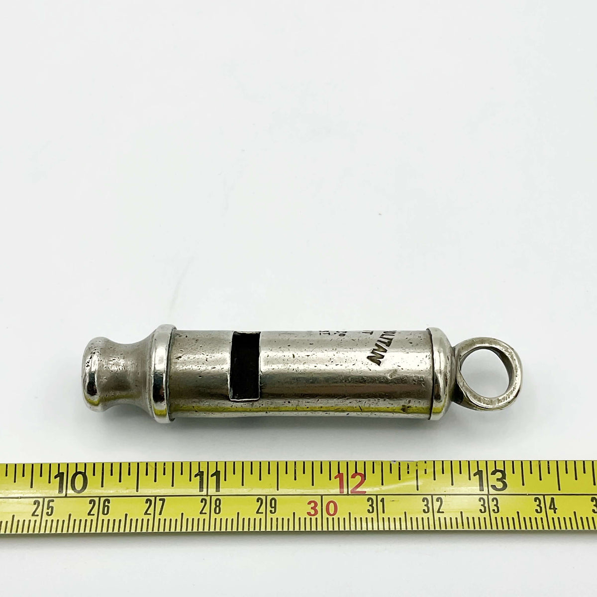 Antique police whistle from Beeches Vintage, a vintage metal accessory with a classic design and chain attachment.