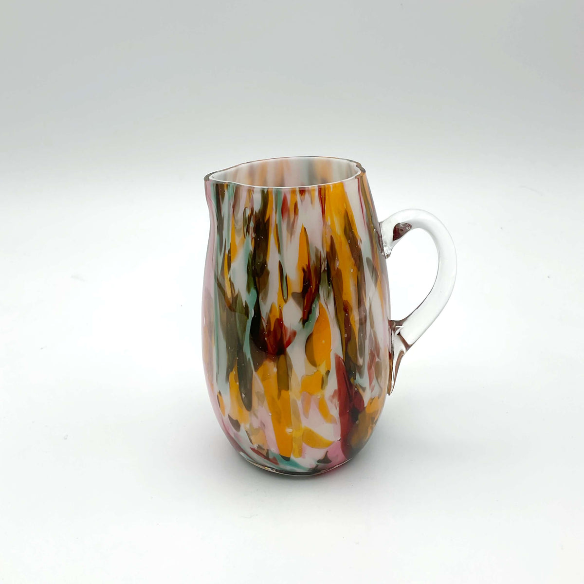 Small handmade vintage art glass cream jug by Beeches Vintage, featuring a delicate, colorful design and elegant shape.