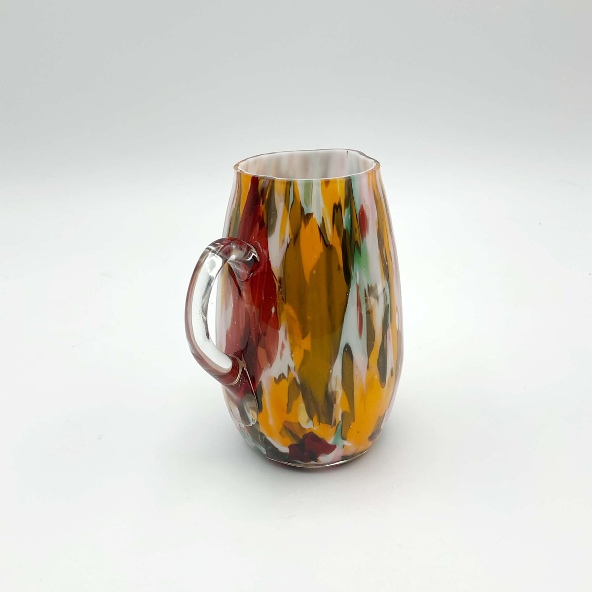 Small handmade vintage art glass cream jug by Beeches Vintage with a smooth, curved design and clear glass finish.