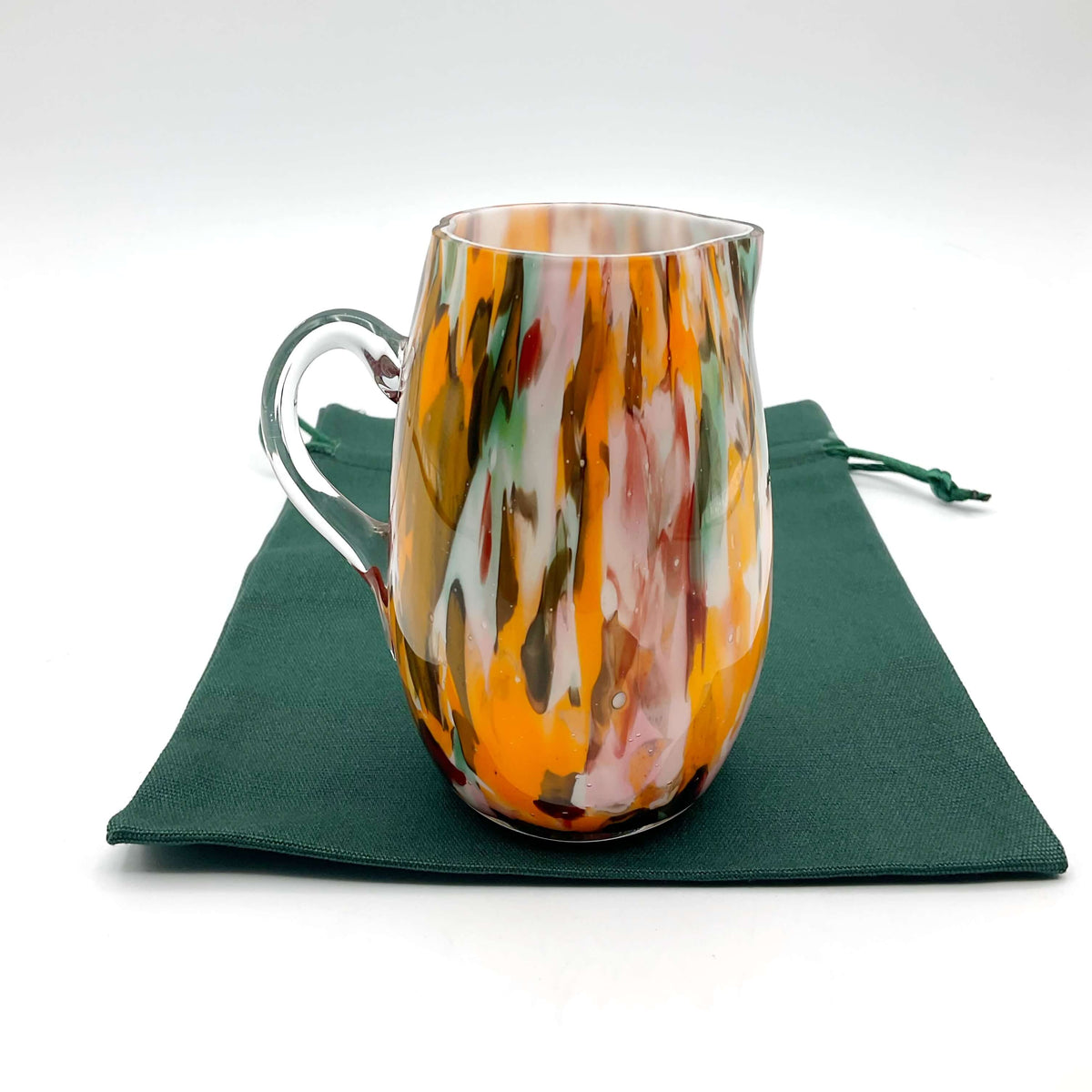 Small handmade vintage art glass cream jug by Beeches Vintage, featuring a delicate, colorful glass design and elegant shape.