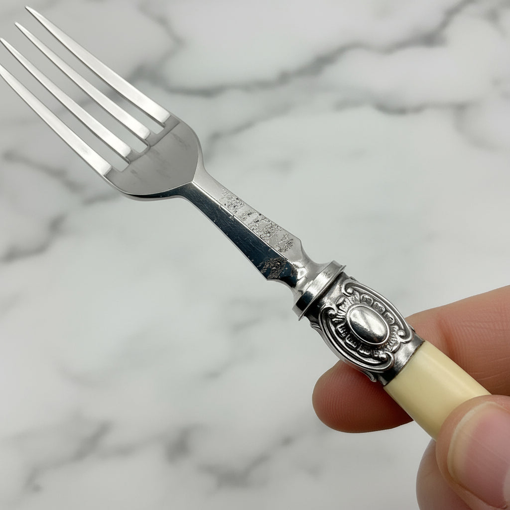 fork with some deterioration to the neck with a marble background