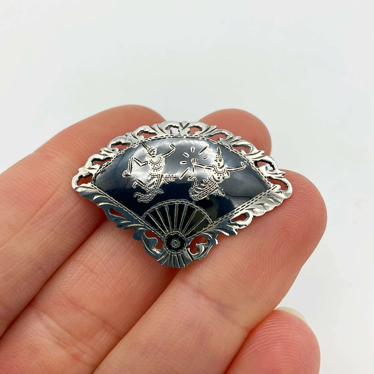 Beautiful Silver Niello Brooch held in a hand