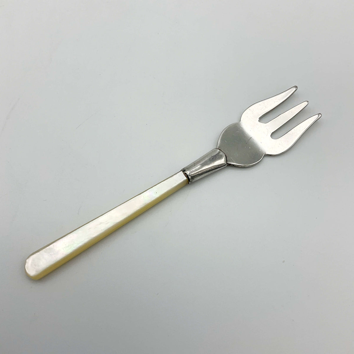 Small silver plated pickle fork with a mother of pearl handle from Beeches Vintage, perfect for serving olives.