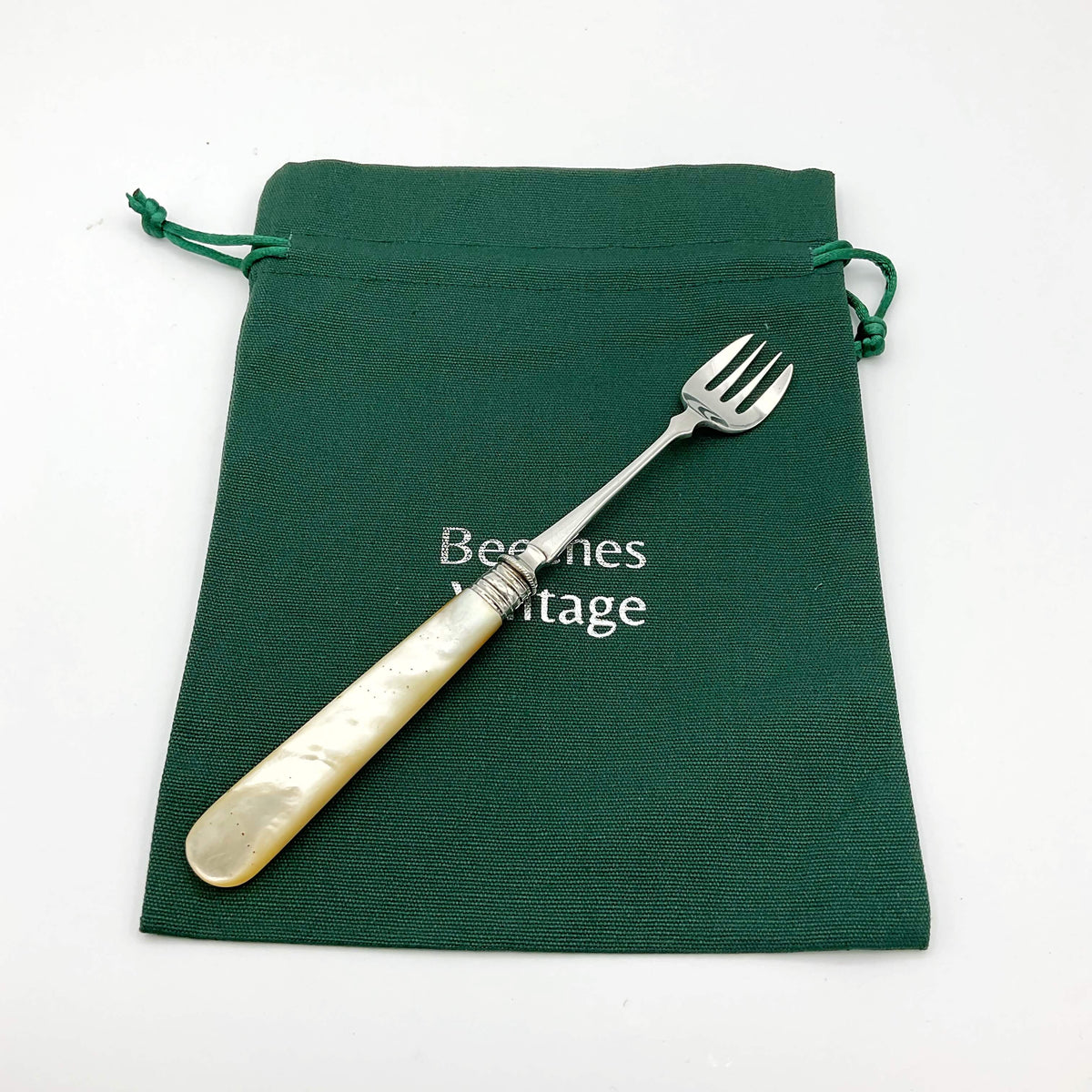 Vintage silver plated pickle fork with a mother of pearl handle by Beeches Vintage, showing detailed craftsmanship and elegant design.