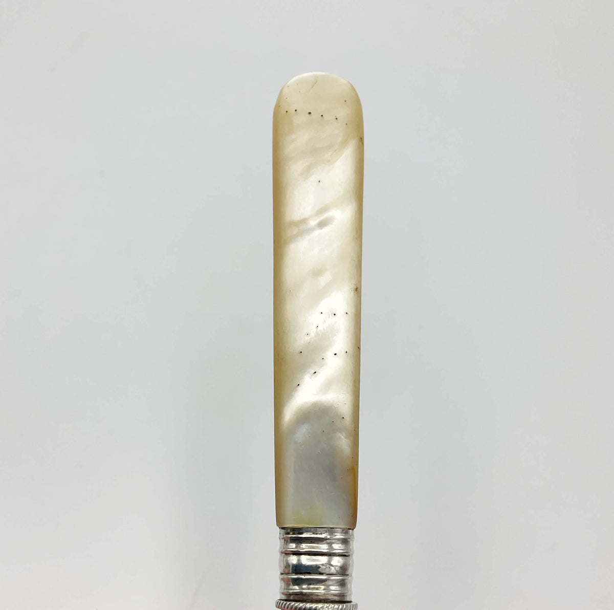 Vintage silver-plated pickle fork with a mother of pearl handle by Beeches Vintage, showing intricate design and polished finish.