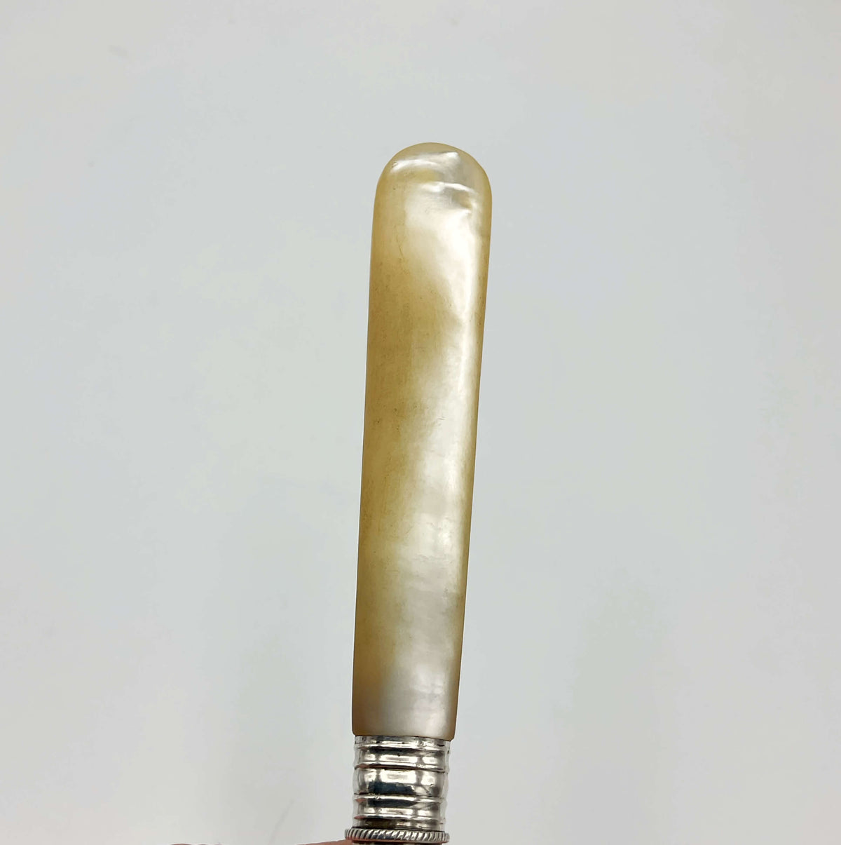 Vintage silver-plated pickle fork with a mother of pearl handle by Beeches Vintage, showcasing its elegant design and craftsmanship.