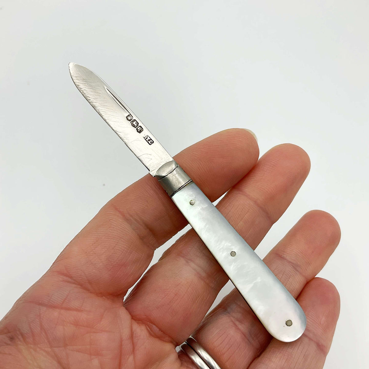 Vintage 1928 Beeches Vintage sterling silver fruit knife with ornate handle and sharp blade, displayed on a neutral background.