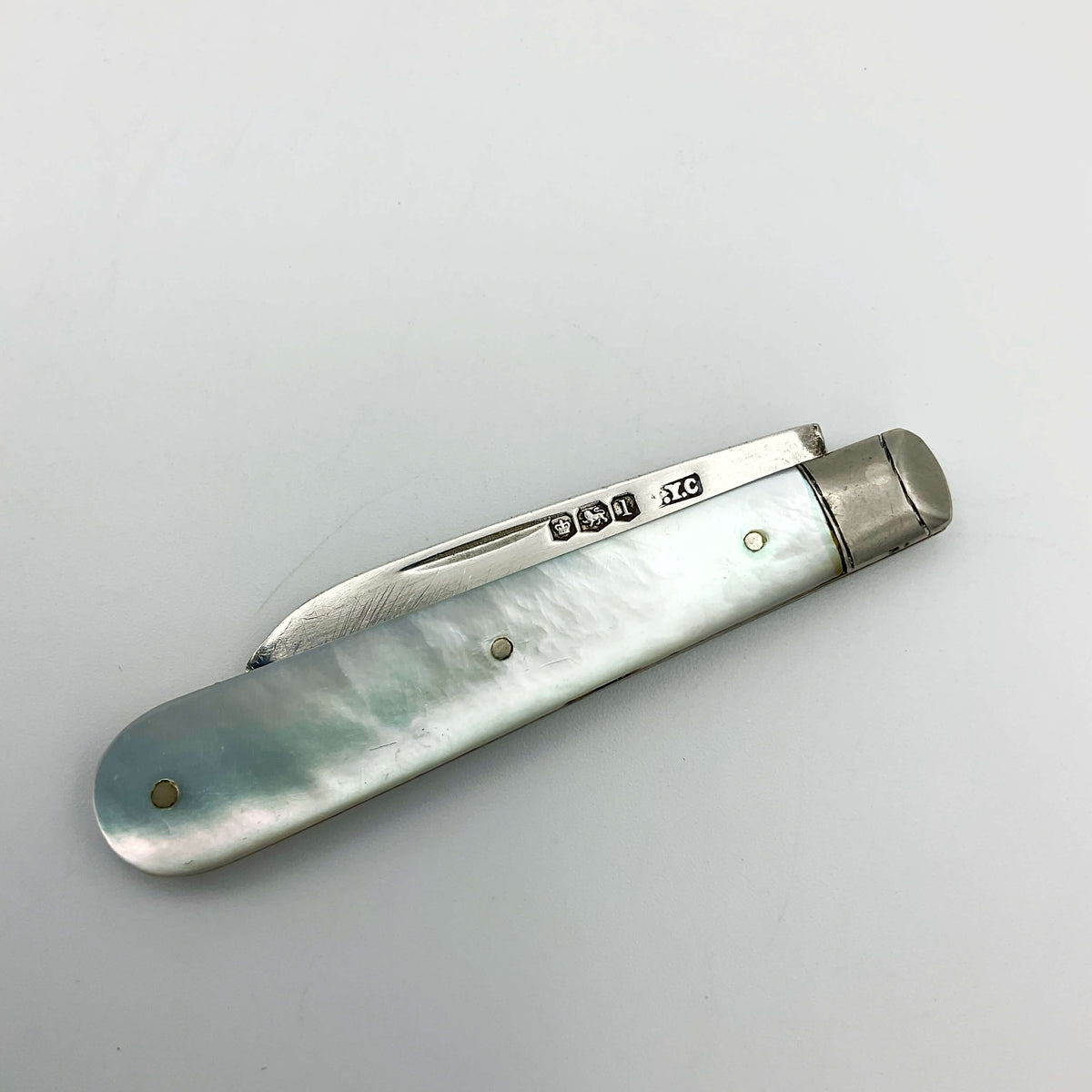 Vintage 1928 Beeches Vintage sterling silver fruit knife with ornate handle and sharp blade on a white background.