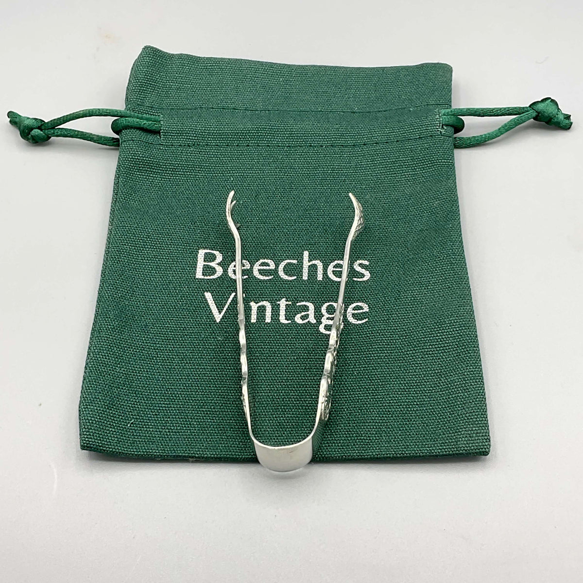 Antique 1902 sterling silver sugar tongs by Beeches Vintage, small ornate design with intricate detailing, vintage tableware accessory.