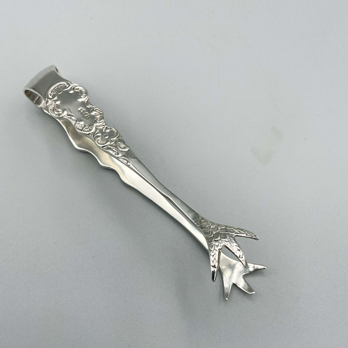 Antique 1902 Sterling Silver Sugar Tongs with ornate design, crafted by Beeches Vintage, vintage silverware for elegant tea settings.