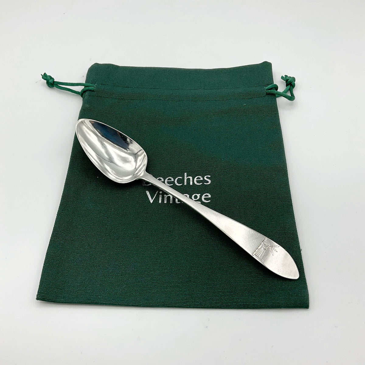 Antique Beeches Vintage solid silver dessert spoon from 1788 with ornate handle and classic design, reflecting vintage craftsmanship.