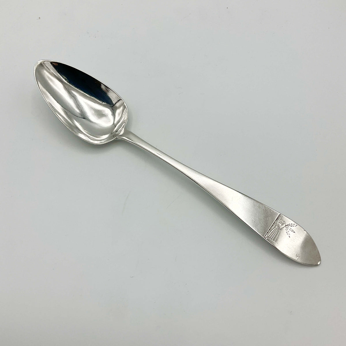Antique 1788 solid silver dessert spoon from Beeches Vintage, featuring intricate engraved detailing and a classic design.