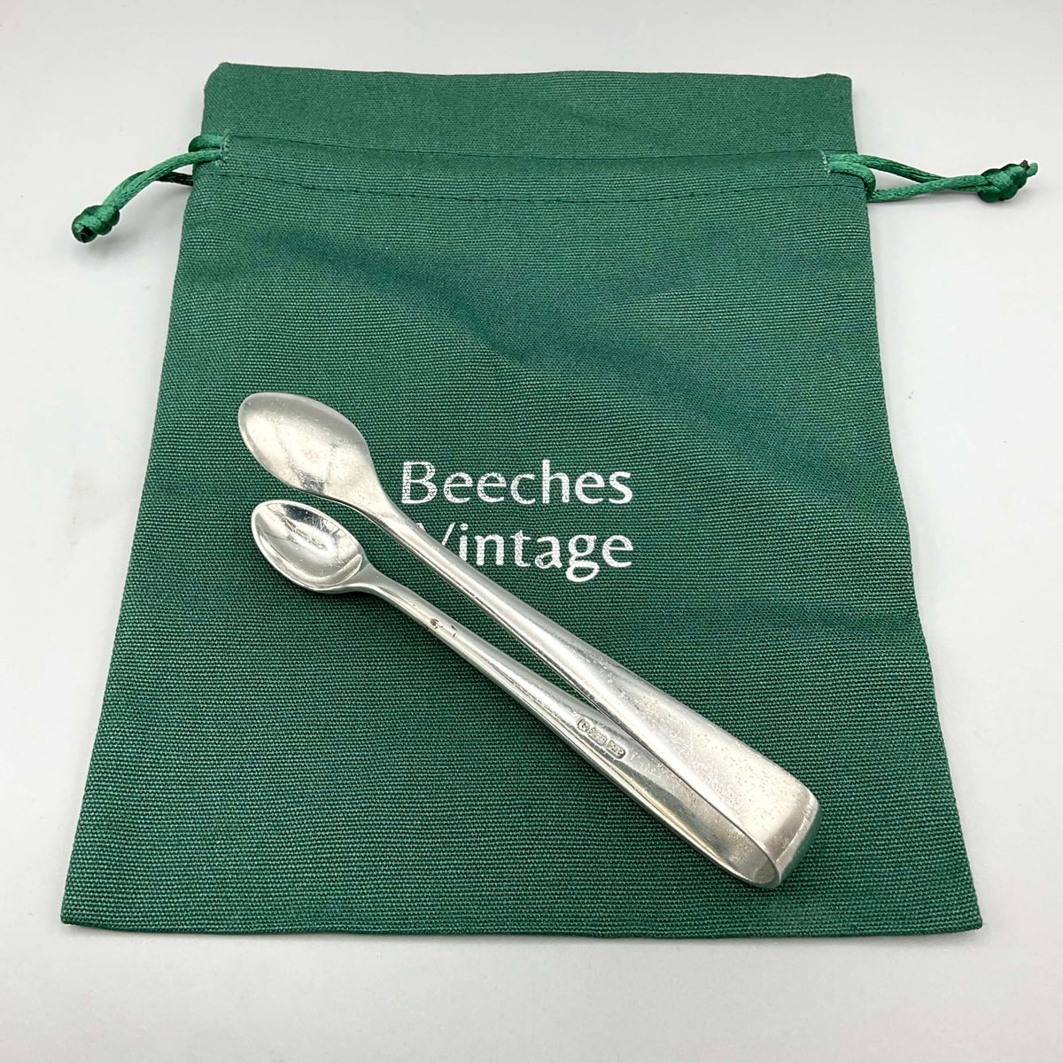 Vintage silver plated sugar tongs by Beeches Vintage, featuring elegant design and polished finish for serving sugar.