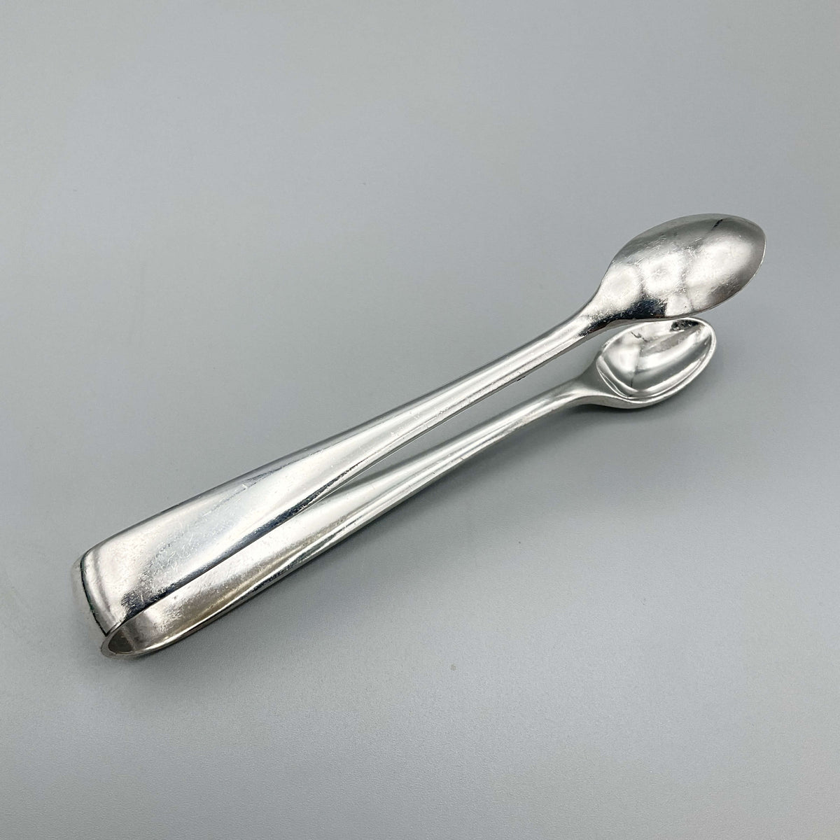Vintage silver-plated Beeches Vintage sugar tongs with elegant design, perfect for serving sugar in classic tea settings.