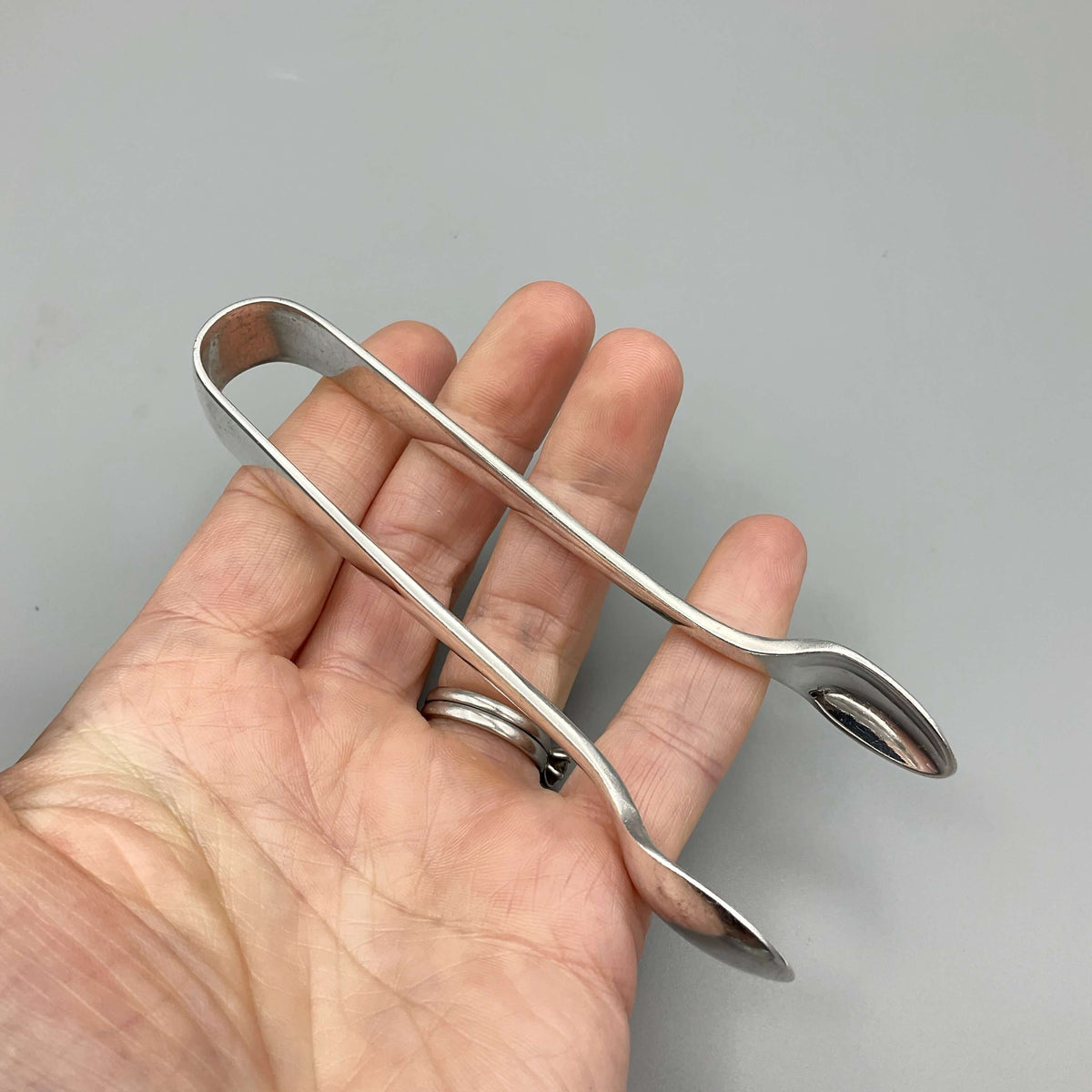 Vintage silver-plated Beeches Vintage sugar tongs with ornate design, perfect for serving sugar in elegant tea settings.