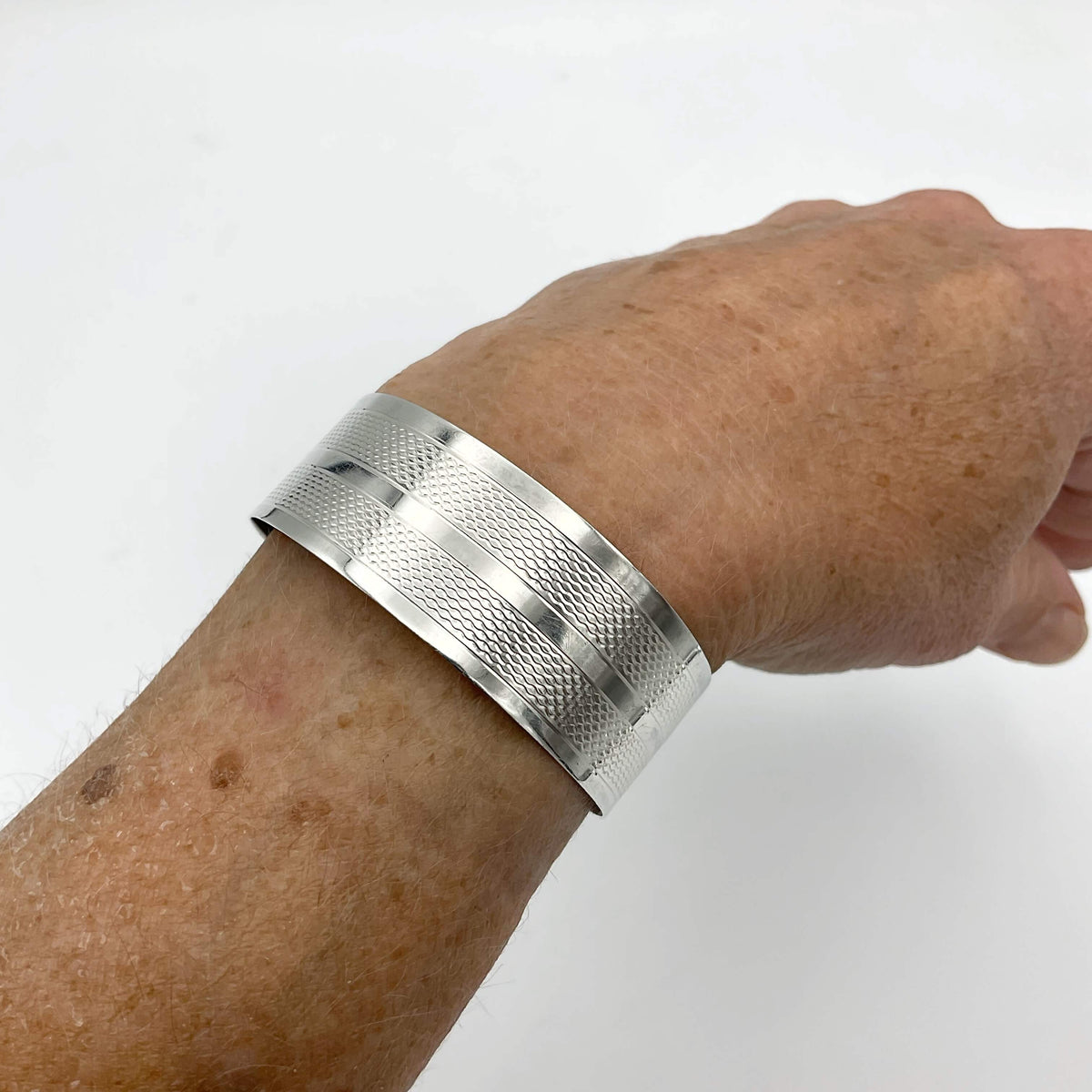 Silver adjustable bangle bracelet from Beeches Vintage, featuring a sleek, minimalist design and smooth finish.