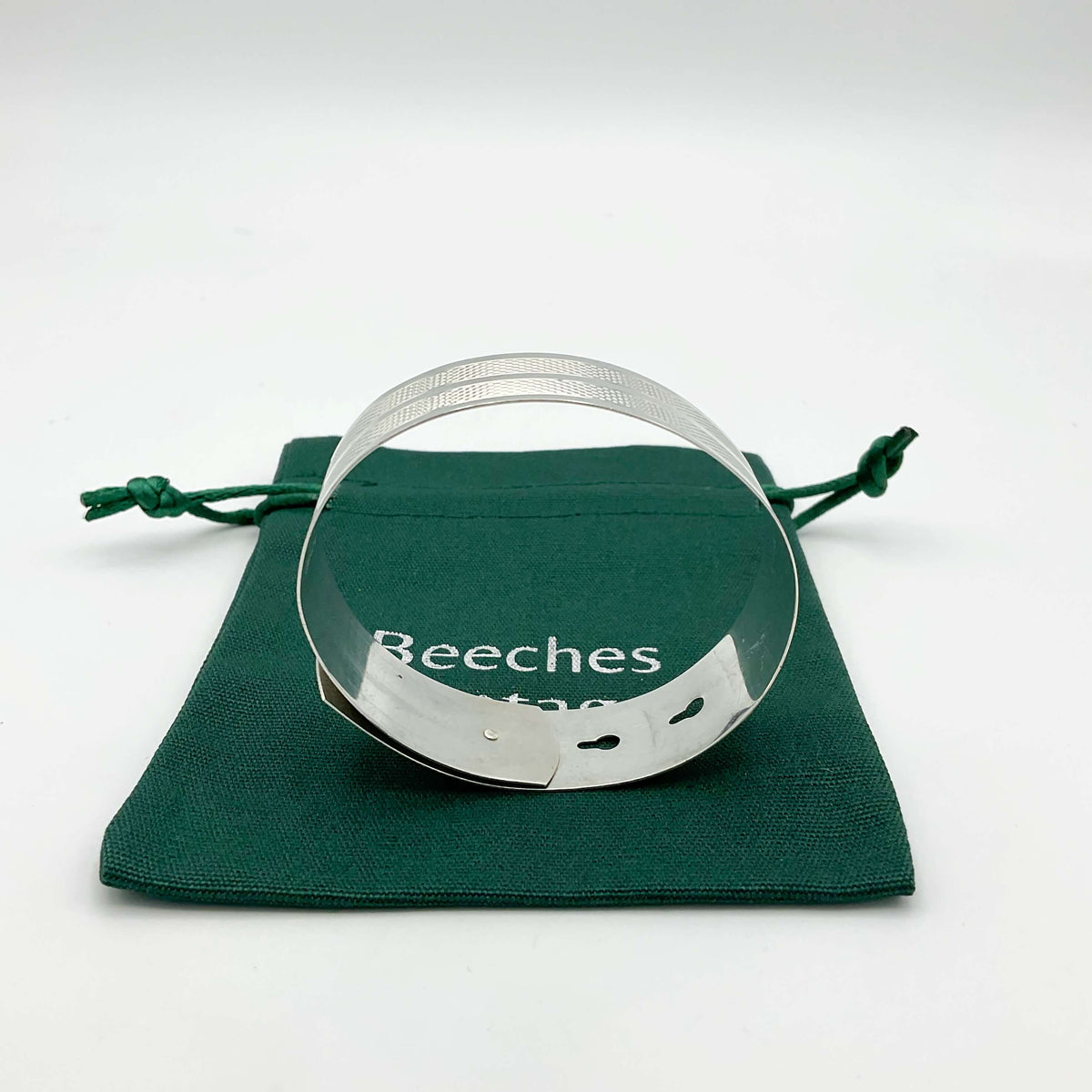 Silver adjustable bangle bracelet by Beeches Vintage featuring a sleek, modern design on a plain background.