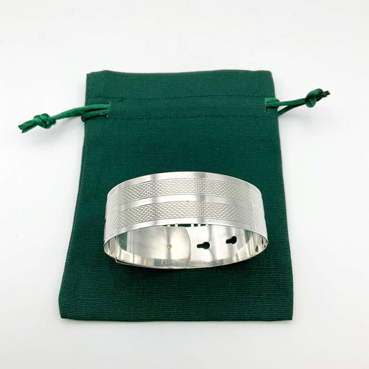 Silver adjustable bangle bracelet by Beeches Vintage, featuring a sleek, minimalist design with smooth curves and open ends.