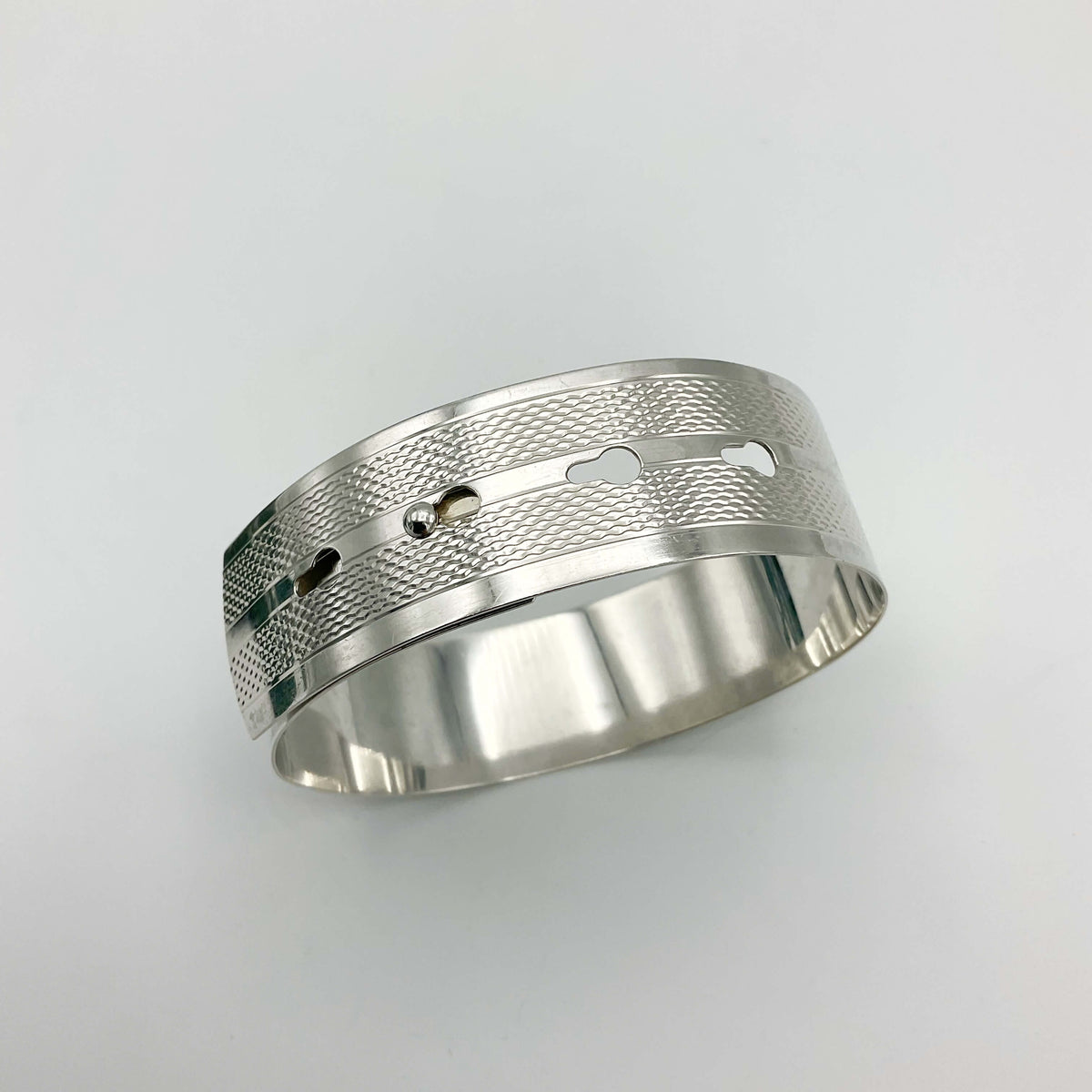 Silver adjustable bangle bracelet by Beeches Vintage, featuring a sleek, minimalist design with smooth, polished surface.