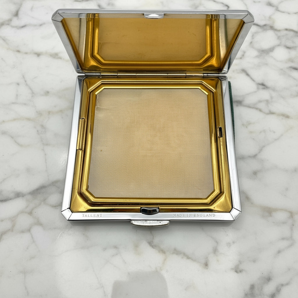Open powder compact with 
Tallent and Made in England on a marble worktop