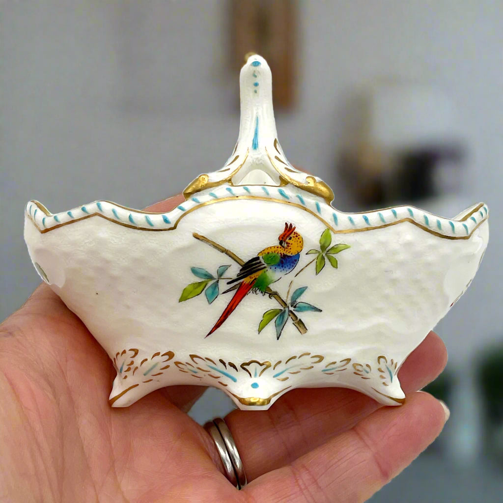 ornament featuring a painted parrot on the side held in a hand in a room