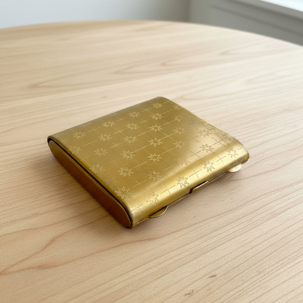 gold powder compact on wood table