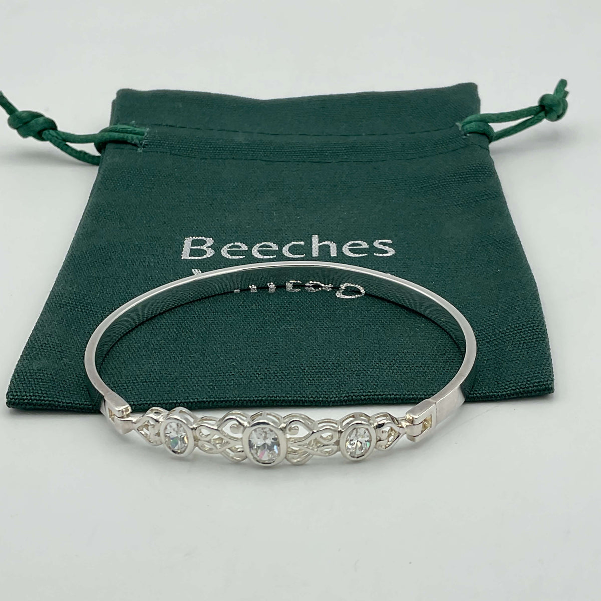 Sterling silver hinged bangle bracelet with cubic zirconia accents, showcasing a polished and elegant design by Beeches Vintage.