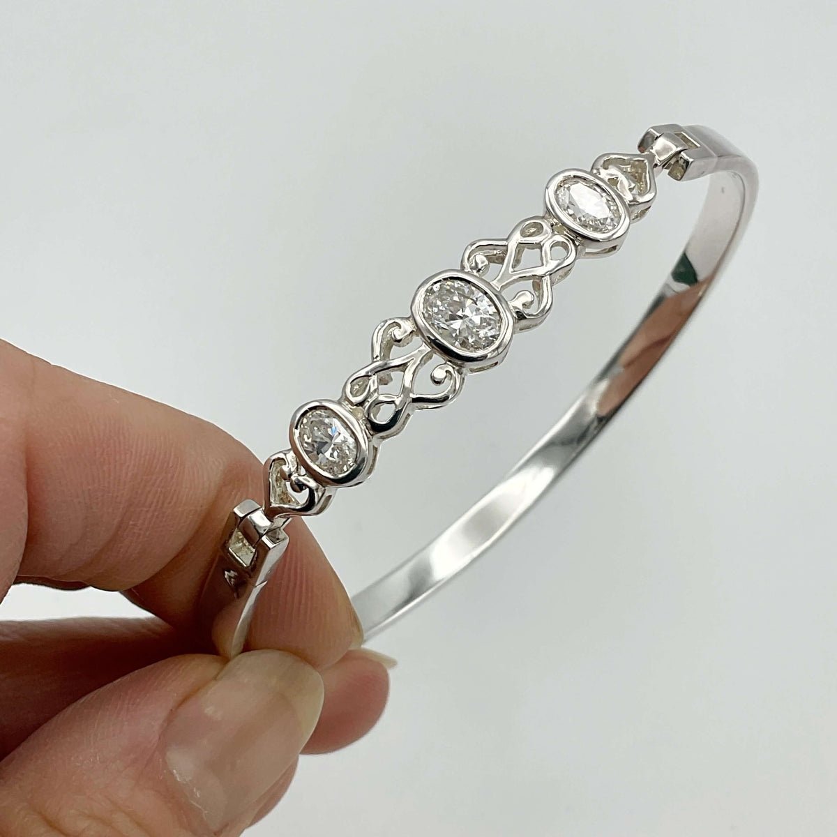 Sterling silver hinged bangle bracelet with sparkling cubic zirconia stones, designed by Beeches Vintage.