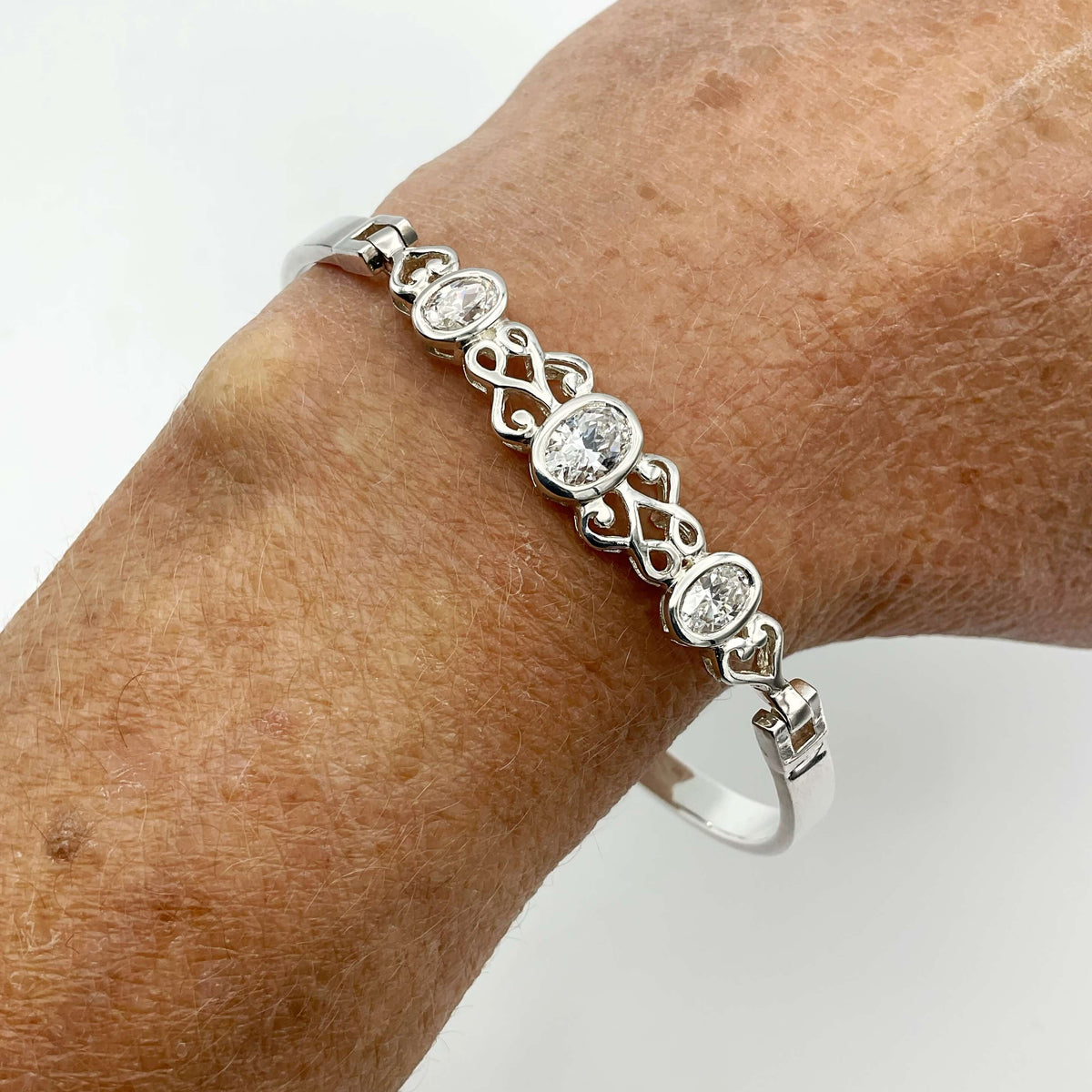 Sterling silver hinged bangle bracelet with cubic zirconia accents from Beeches Vintage, showcasing a polished and elegant design.