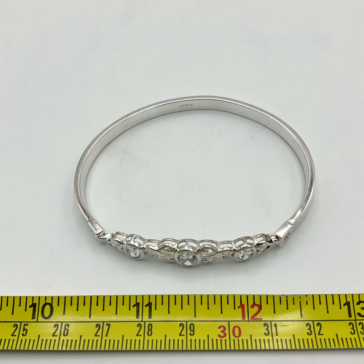 Sterling silver cubic zirconia hinged bangle bracelet by Beeches Vintage with sparkling stones and smooth, polished finish.