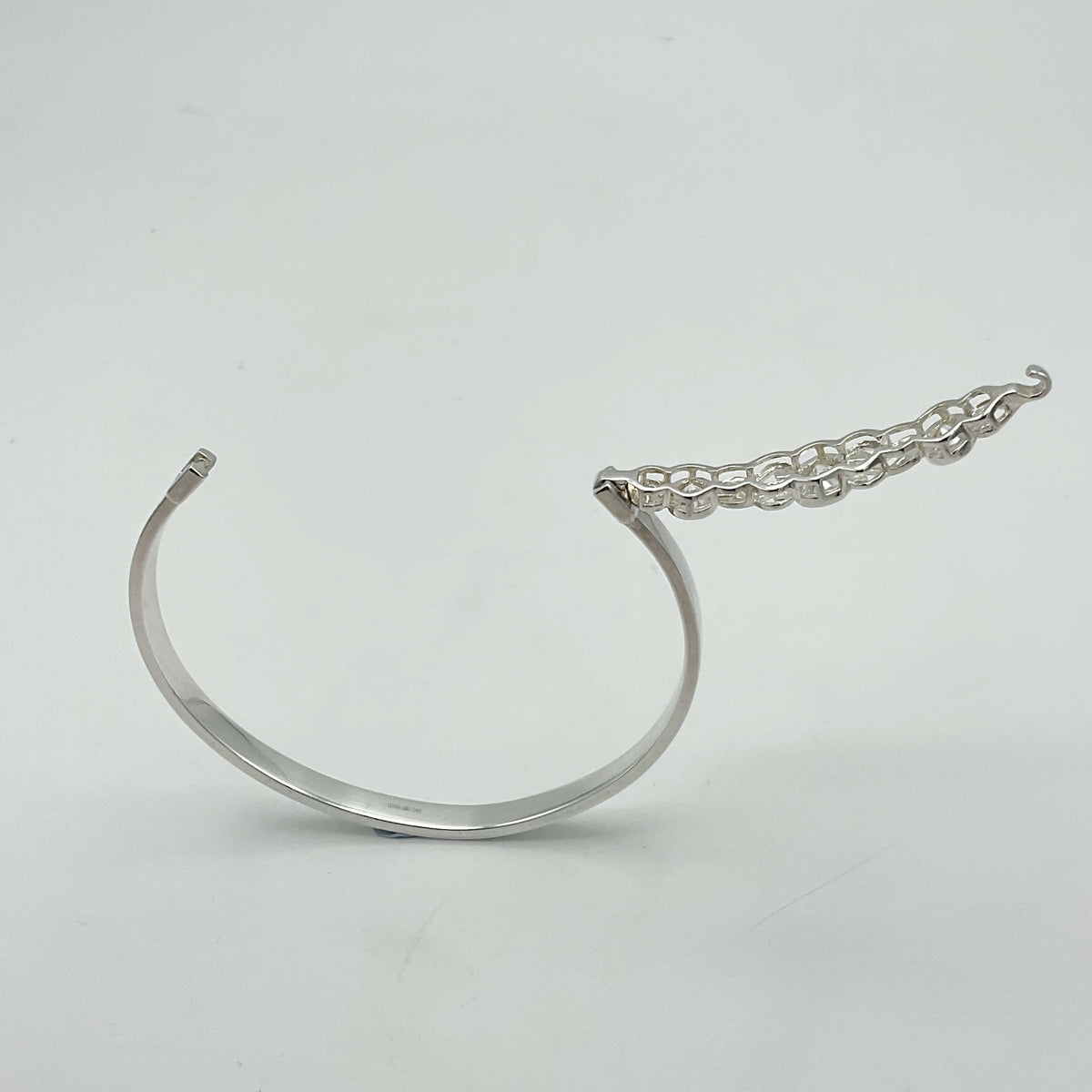 Sterling silver hinged bangle bracelet with cubic zirconia accents, crafted by Beeches Vintage, showcasing a elegant jewelry design.