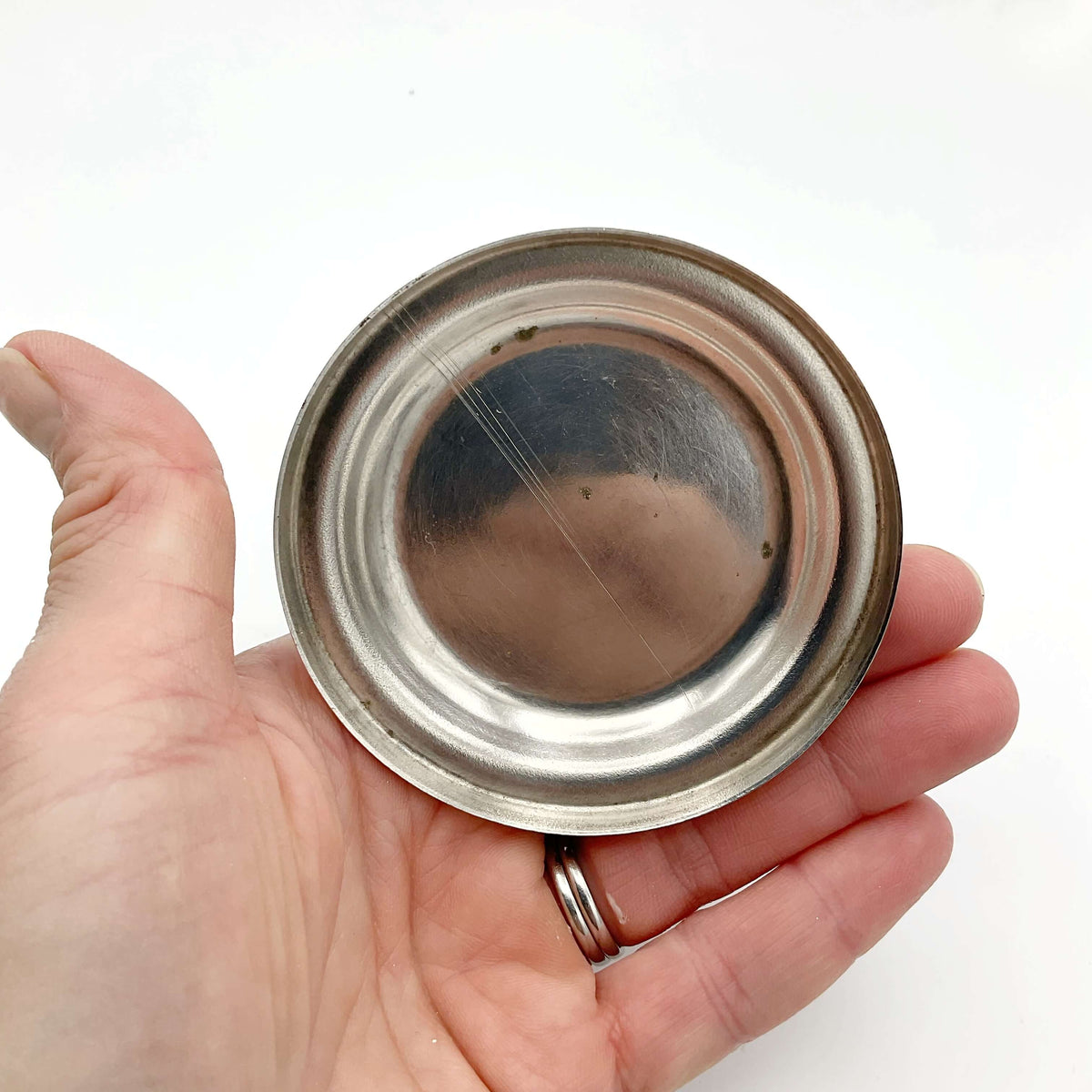 Vintage 1960s silver-plated candle holder from Beeches Vintage, featuring classic candlestick design and intricate detailing.