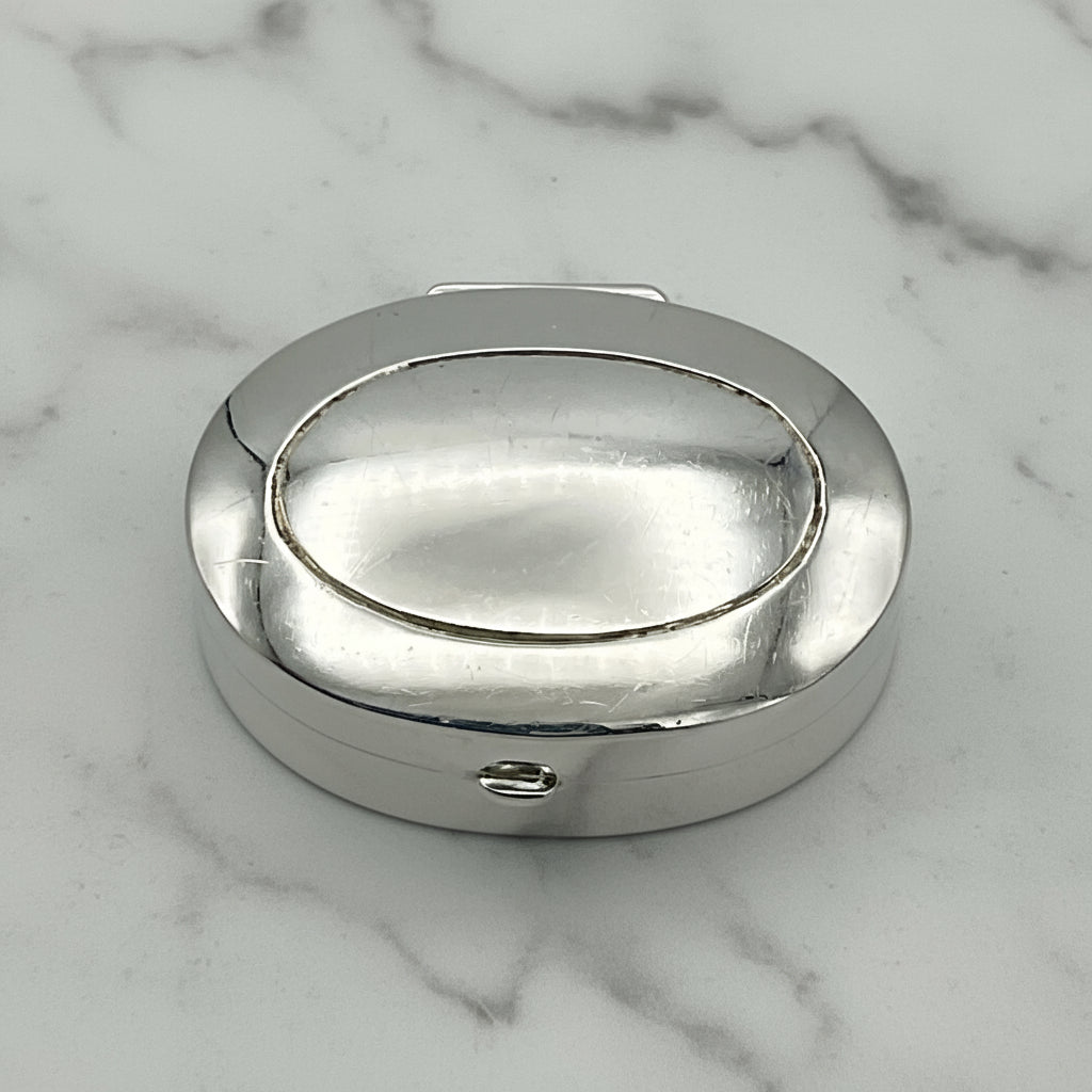 sivler pill box on a marble worktop