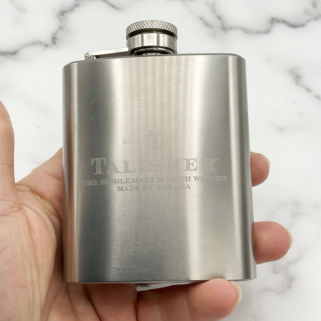 Talisker hip flask held in a hand