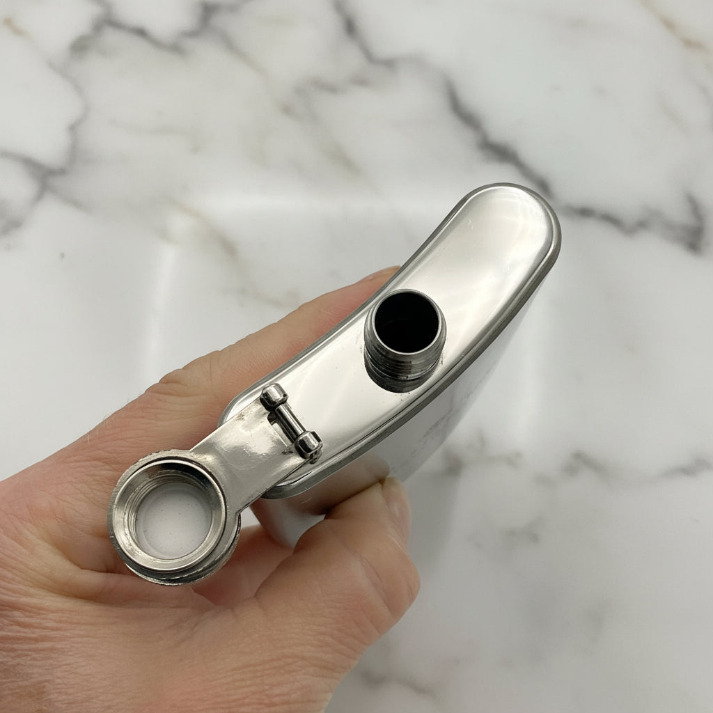 top of hip flask with lid open held in a hand