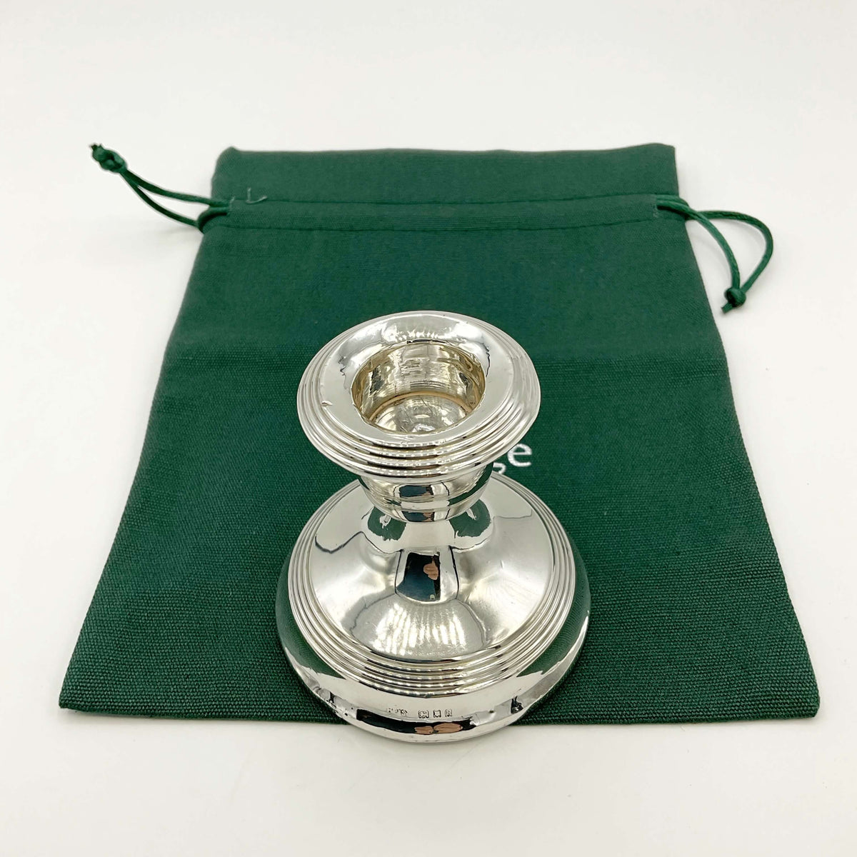 Antique sterling silver candlestick holder from Beeches Vintage with intricate detailing and polished finish.