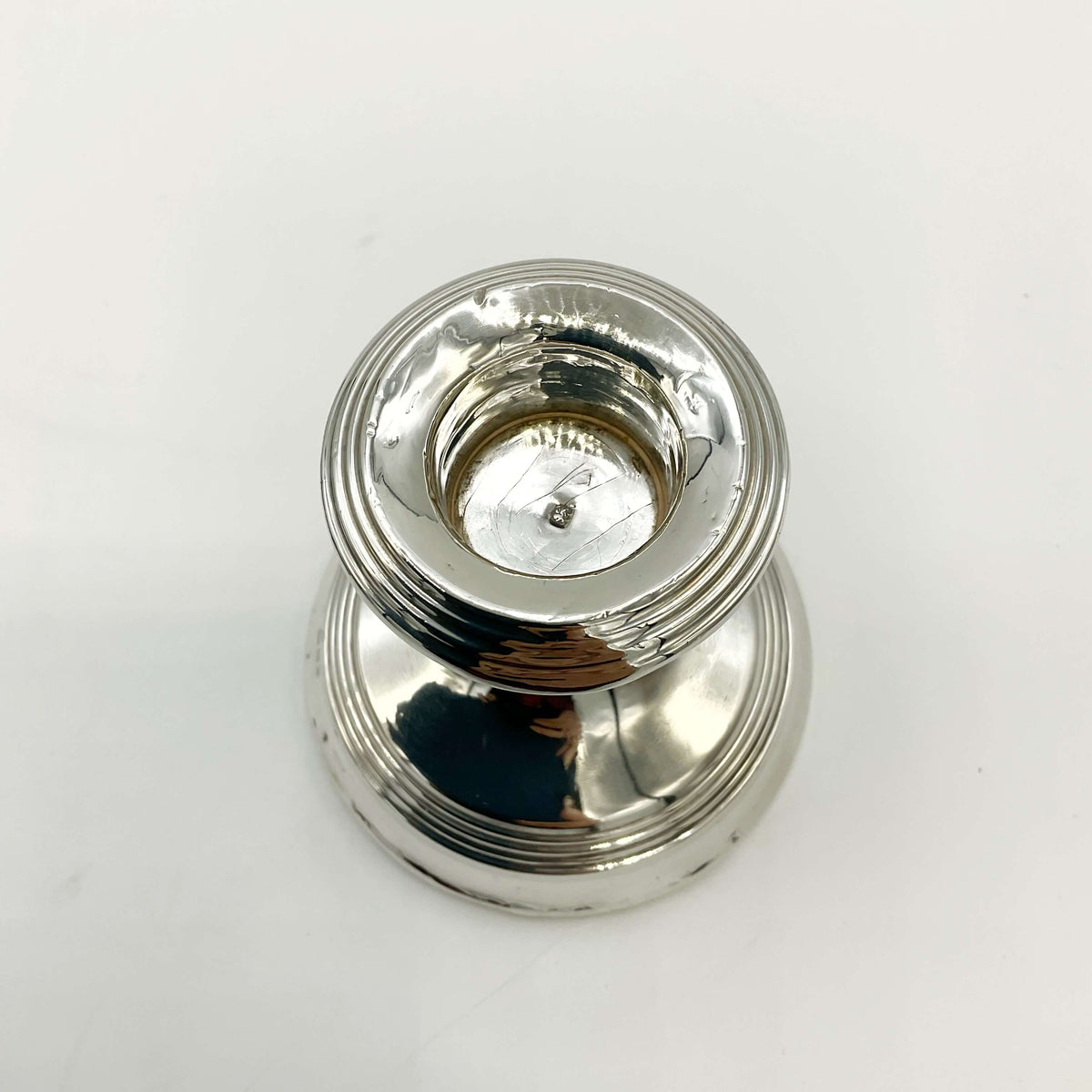 Antique sterling silver candlestick holder from Beeches Vintage, featuring intricate design and polished finish.