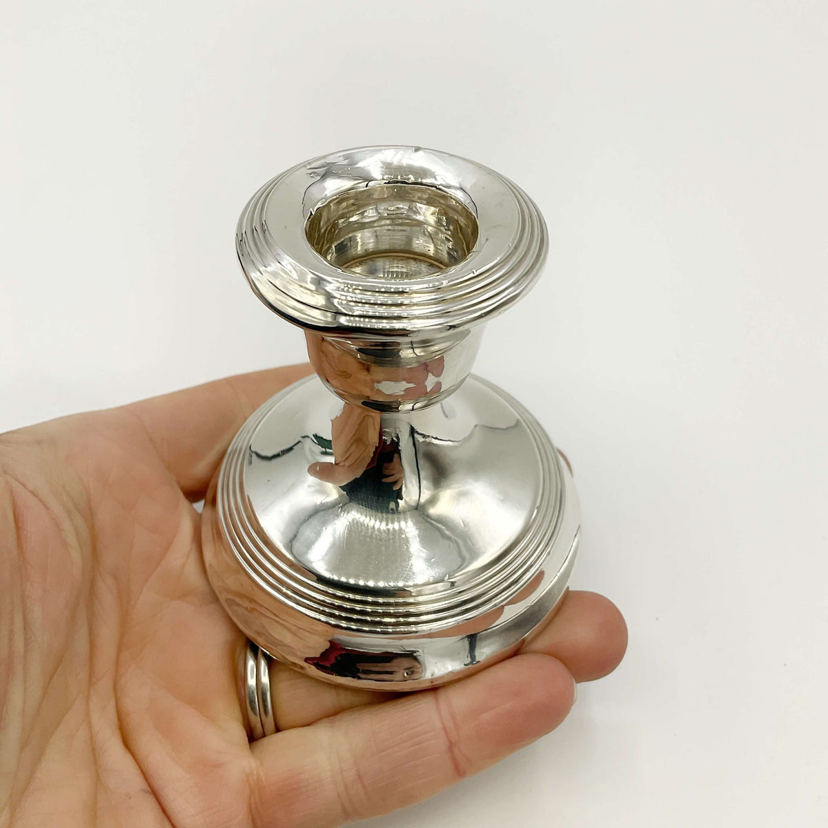 Antique sterling silver candlestick holder from Beeches Vintage with intricate detailing and polished finish.