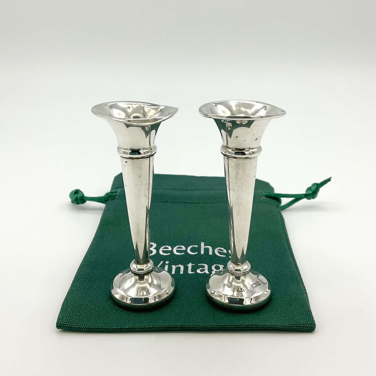 Pair of small sterling silver spill vases with intricate patterns, designed for elegant floral arrangements, by Beeches Vintage.