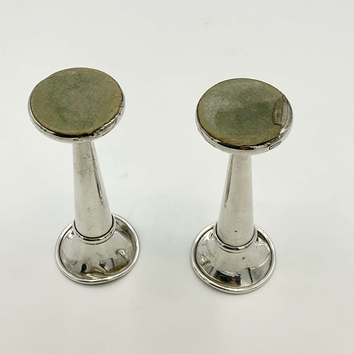Pair of small sterling silver spill vases by Beeches Vintage, featuring intricate floral engravings and classic vase shapes.