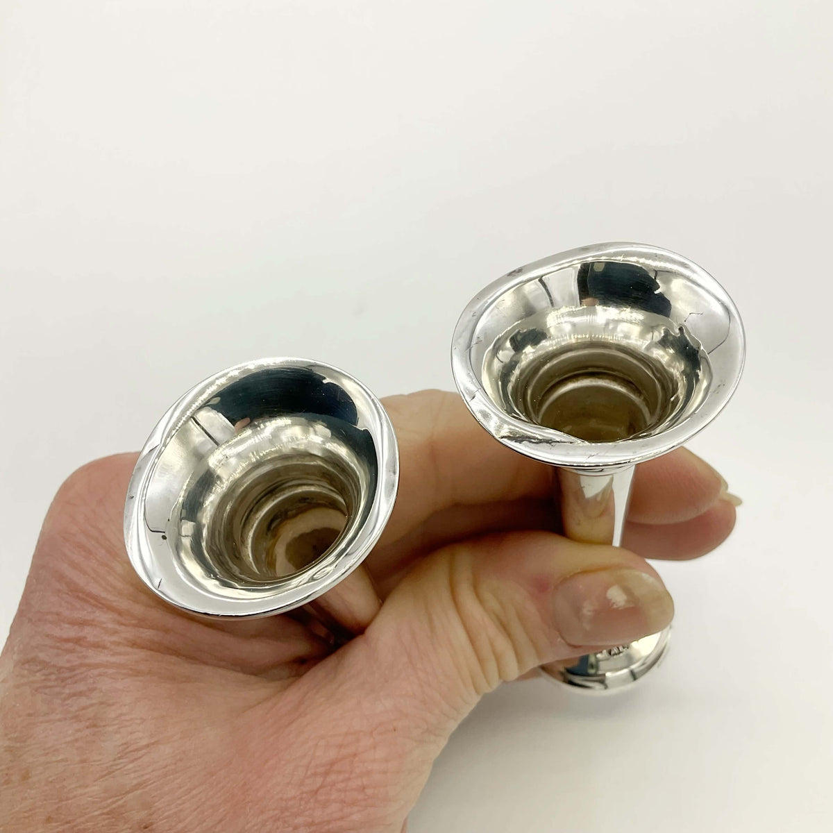 Pair of small sterling silver spill vases with intricate details from Beeches Vintage, ideal for floral arrangements.